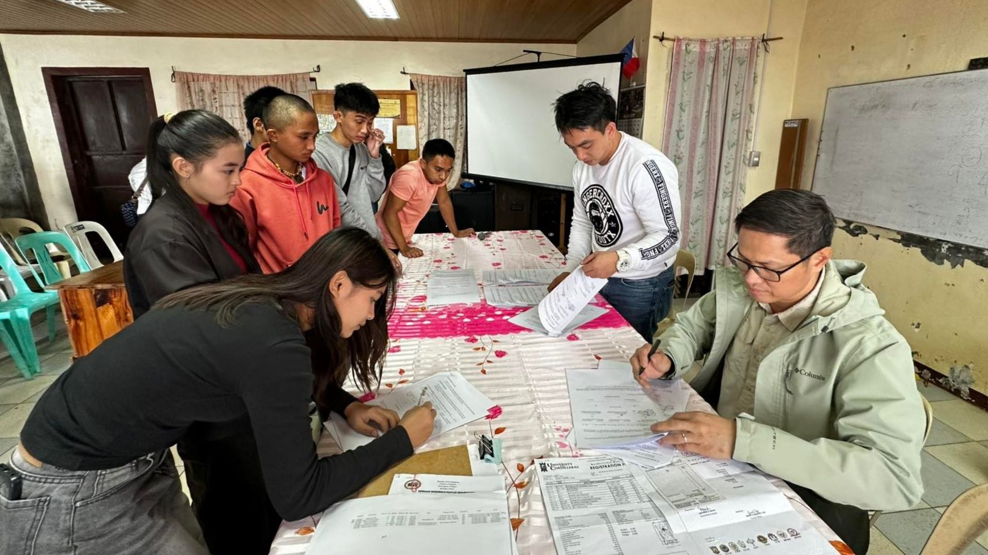 Members of the Barangay Loacan community witness the signing of the Mt. Camisong Scholarship Program Memorandum of Agreement